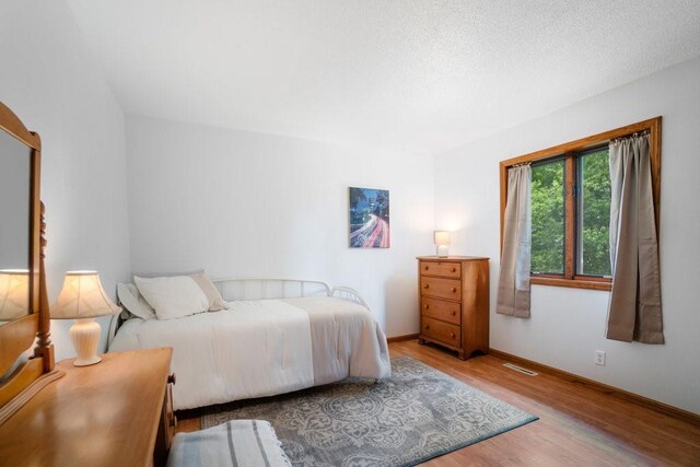 4129 Birch Crest Ln, Eau Claire, WI 54701 - bedroom featuring wood finished floors and baseboards