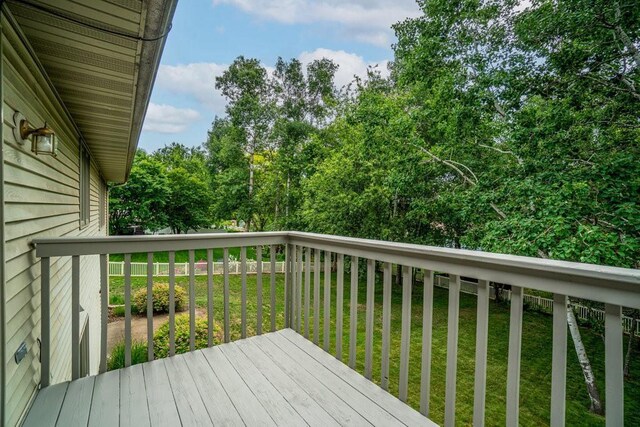 4129 Birch Crest Ln, Eau Claire, WI 54701 - wooden deck with a lawn and view of scattered trees