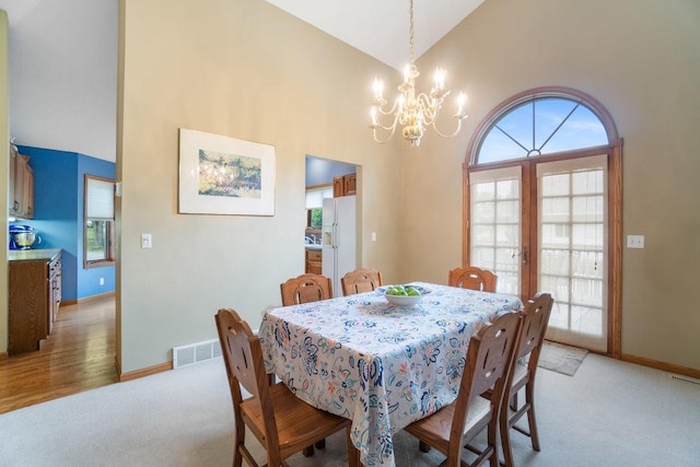 4129 Birch Crest Ln, Eau Claire, WI 54701 - dining space with a chandelier, high vaulted ceiling, light carpet, and plenty of natural light