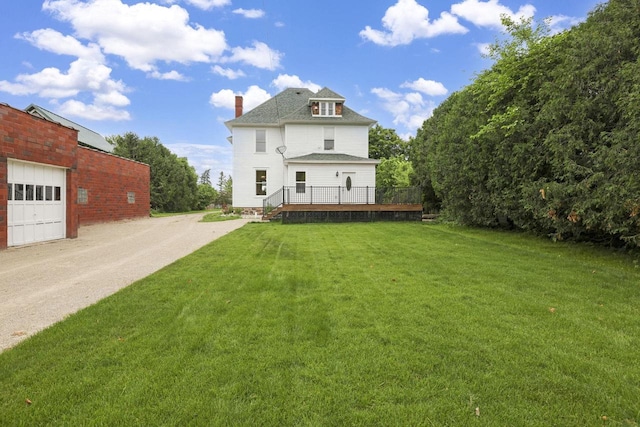 205 W Main St, Weyauwega, WI 54983 - rear view of property with a chimney, a lawn, a deck, driveway, and roof with shingles