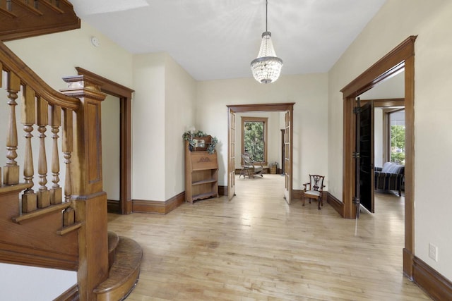 205 W Main St, Weyauwega, WI 54983 - entrance foyer featuring plenty of natural light, light wood finished floors, a chandelier, and stairs