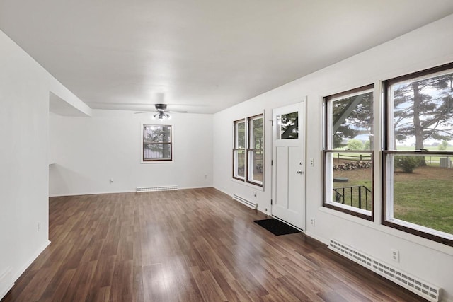 W2726 Marion St, Neshkoro, WI 54960 - spare room featuring baseboard heating, dark wood-style floors, and a ceiling fan