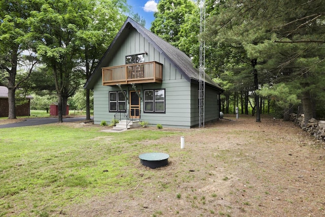 W2726 Marion St, Neshkoro, WI 54960 - view of front of house featuring a balcony, board and batten siding, and a front yard