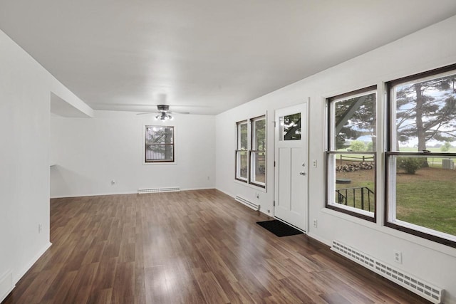 W2726 Marion St, Neshkoro, WI 54960 - spare room featuring baseboard heating, ceiling fan, and dark wood-type flooring