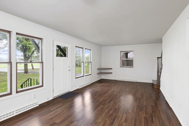 W2726 Marion St, Neshkoro, WI 54960 - unfurnished living room with wood finished floors and a baseboard radiator