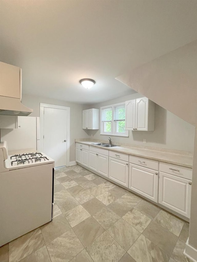 133 W 16th Ave, Oshkosh, WI 54902 - kitchen featuring white gas stove, under cabinet range hood, white cabinetry, and light countertops