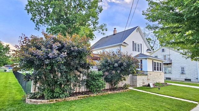 553 W 17th Ave, Oshkosh, WI 54902 - view of home's exterior with stone siding and a chimney