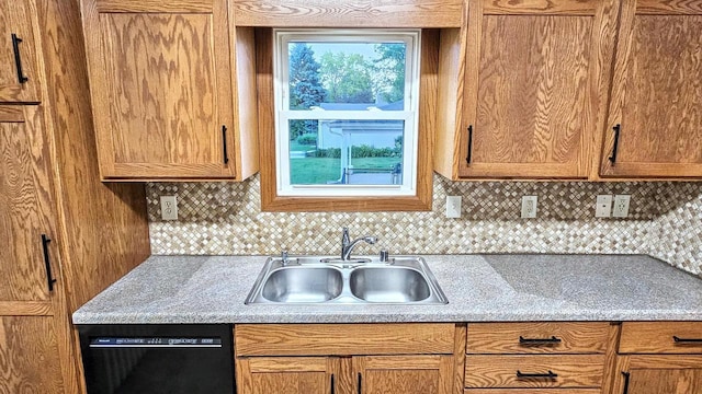 553 W 17th Ave, Oshkosh, WI 54902 - kitchen featuring black dishwasher, backsplash, light countertops, and brown cabinetry