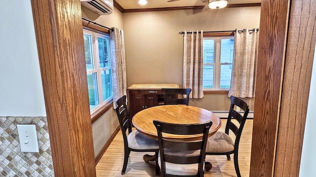 553 W 17th Ave, Oshkosh, WI 54902 - dining room featuring healthy amount of natural light, light wood-type flooring, a wall unit AC, ornamental molding, and a textured wall