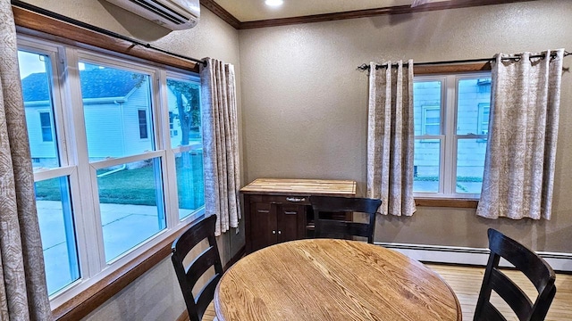 553 W 17th Ave, Oshkosh, WI 54902 - dining space with a textured wall, wood finished floors, and crown molding
