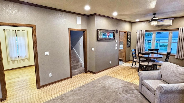 553 W 17th Ave, Oshkosh, WI 54902 - living area featuring a textured wall, crown molding, light wood-style floors, an AC wall unit, and ceiling fan