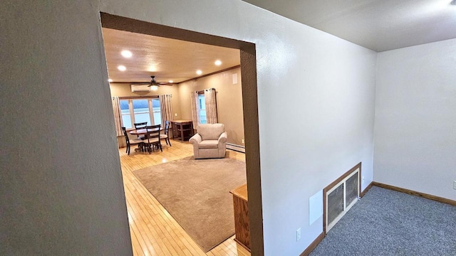 553 W 17th Ave, Oshkosh, WI 54902 - corridor featuring baseboard heating, recessed lighting, and wood finished floors
