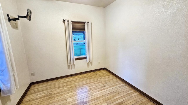 553 W 17th Ave, Oshkosh, WI 54902 - spare room featuring light wood-style flooring and baseboards