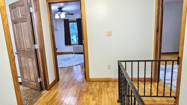 553 W 17th Ave, Oshkosh, WI 54902 - hall featuring an upstairs landing, radiator, and light wood finished floors