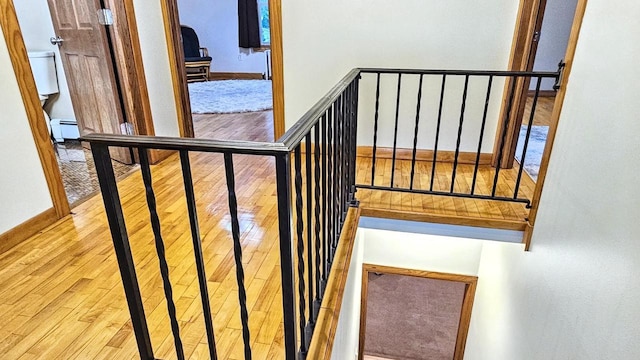 553 W 17th Ave, Oshkosh, WI 54902 - stairway featuring hardwood / wood-style flooring and a baseboard radiator