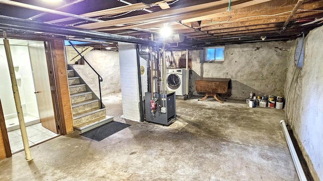 553 W 17th Ave, Oshkosh, WI 54902 - basement featuring washer / clothes dryer, stairs, and a baseboard heating unit