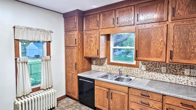 553 W 17th Ave, Oshkosh, WI 54902 - kitchen with radiator, dishwasher, decorative backsplash, and light countertops