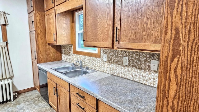 553 W 17th Ave, Oshkosh, WI 54902 - kitchen featuring radiator, decorative backsplash, dishwasher, and light countertops