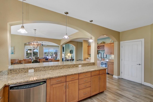 650 E Hiawatha Dr Unit 312, Wisconsin Dells, WI 53965 - kitchen with stainless steel dishwasher, light wood finished floors, beverage cooler, arched walkways, and light stone countertops
