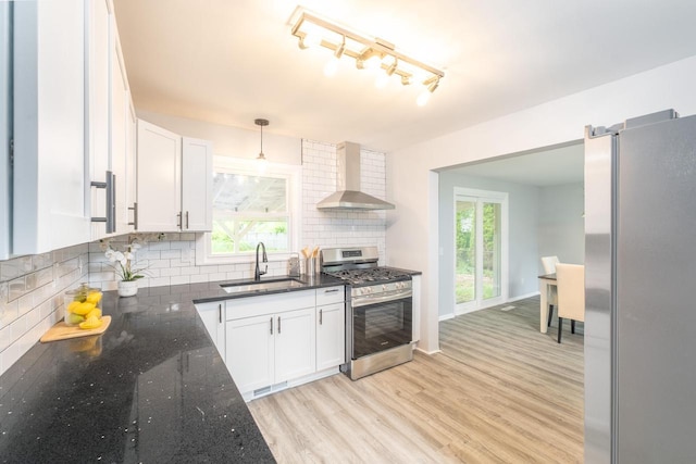 11114 8th Ave, Pleasant Prairie, WI 53158 - kitchen featuring stainless steel appliances, wall chimney range hood, white cabinets, and light wood-type flooring