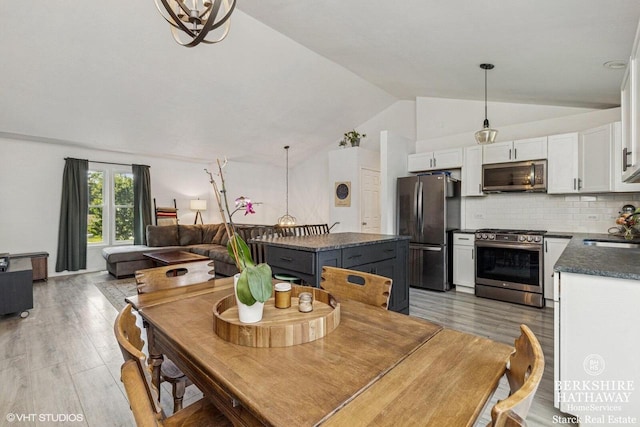 W1018 Larkspur Rd, Genoa City, WI 53128 - dining room with vaulted ceiling and light wood-style flooring