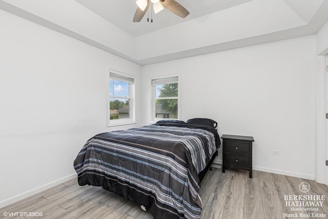 W1018 Larkspur Rd, Genoa City, WI 53128 - bedroom with wood finished floors, a ceiling fan, and a tray ceiling
