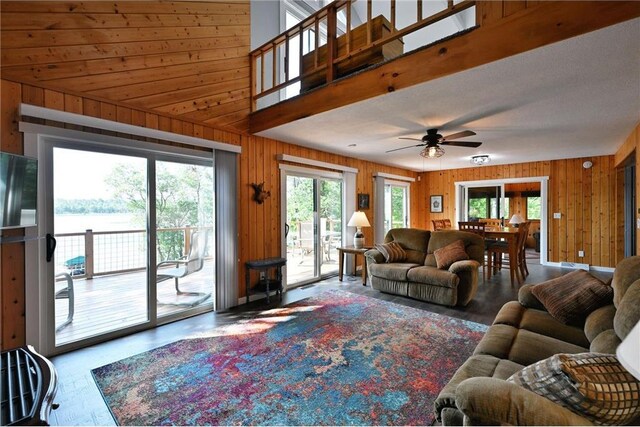 33516 No Mans Trl, Minong, WI 54859 - living area featuring wood walls, a wood stove, and a ceiling fan