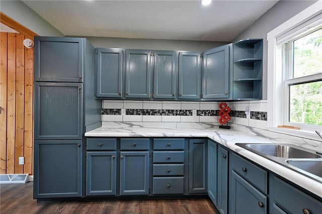 33516 No Mans Trl, Minong, WI 54859 - kitchen featuring backsplash, blue cabinetry, dark wood-style flooring, wooden walls, and recessed lighting