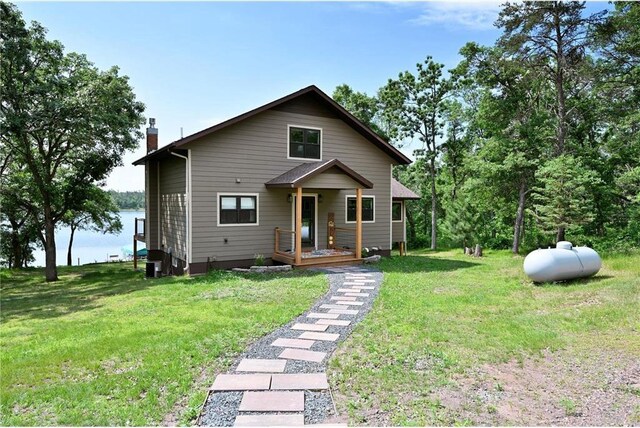 33516 No Mans Trl, Minong, WI 54859 - bungalow featuring a chimney, a front lawn, and a water view