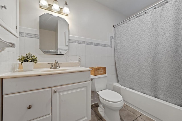 8088 N 65th St, Brown Deer, WI 53223 - full bath featuring vanity, tile patterned floors, tile walls, and shower / bath combo with shower curtain
