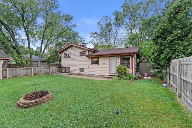 8088 N 65th St, Brown Deer, WI 53223 - back of property with a fenced backyard, a fire pit, and a patio
