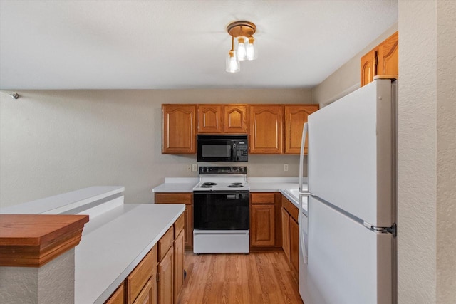 2975 River Birch Dr Unit F, Brookfield, WI 53045 - kitchen with white appliances, light countertops, brown cabinetry, and light wood-type flooring