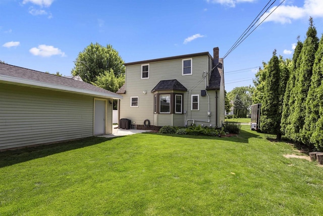 902 E Fremont St, Appleton, WI 54915 - rear view of property with a yard, a chimney, a garage, and a patio area