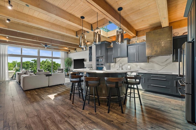 N52W35002 Lake Dr Unit 302, Okauchee, WI 53069 - kitchen with open floor plan, a wood ceiling with exposed beams, decorative backsplash, dark wood-type flooring, and a breakfast bar area