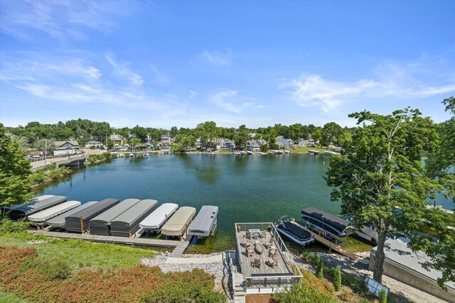 N52W35002 Lake Dr Unit 302, Okauchee, WI 53069 - dock area featuring a water view and view of wooded area