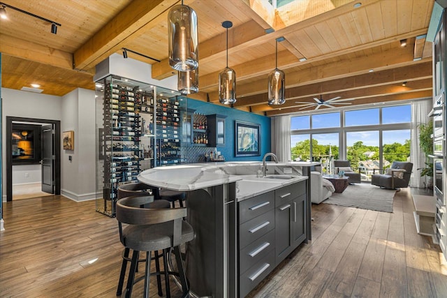N52W35002 Lake Dr Unit 302, Okauchee, WI 53069 - wine room featuring a wood ceiling with exposed beams, dark wood finished floors, ceiling fan, and track lighting