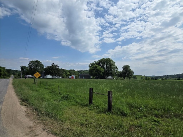 N35182 Weverstad Rd, Blair, WI 54616 - view of dirt / gravel road featuring a view of countryside and traffic signs