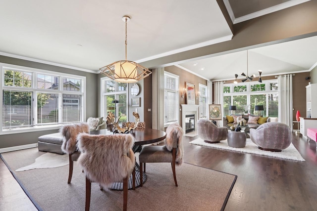 16885 Lake Rd Unit A, Brookfield, WI 53005 - dining space featuring crown molding, wood finished floors, and a glass covered fireplace