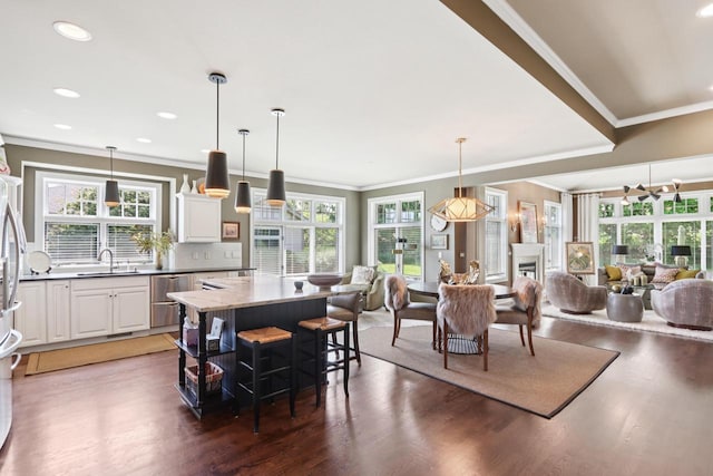 16885 Lake Rd Unit A, Brookfield, WI 53005 - kitchen with wood finished floors, a kitchen island, appliances with stainless steel finishes, a breakfast bar area, and open floor plan