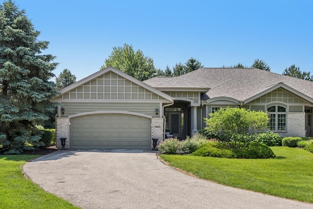 16885 Lake Rd Unit A, Brookfield, WI 53005 - view of front facade with asphalt driveway, brick siding, a front lawn, and an attached garage