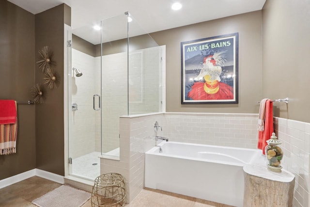 16885 Lake Rd Unit A, Brookfield, WI 53005 - bathroom with a bath, a stall shower, tile walls, and tile patterned floors