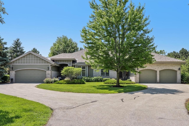 16885 Lake Rd Unit A, Brookfield, WI 53005 - view of front of property with an attached garage, brick siding, a front lawn, asphalt driveway, and roof with shingles