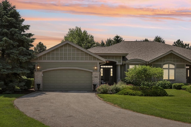 16885 Lake Rd Unit A, Brookfield, WI 53005 - view of front of house with driveway, a garage, a front lawn, a shingled roof, and brick siding
