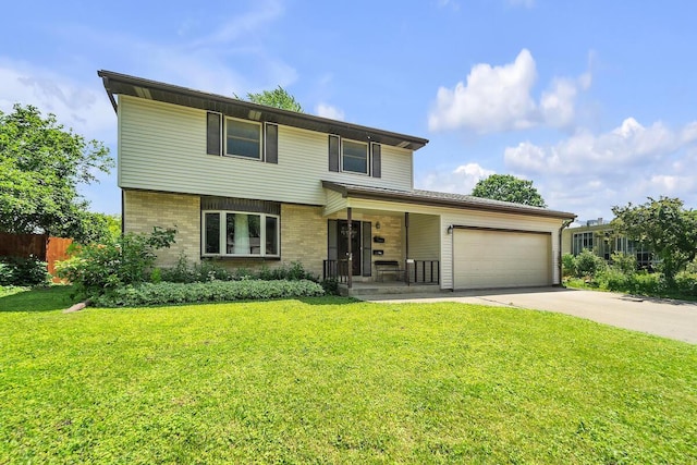 2131 Empire Dr, Waukesha, WI 53186 - view of front of property featuring an attached garage, driveway, a porch, and brick siding