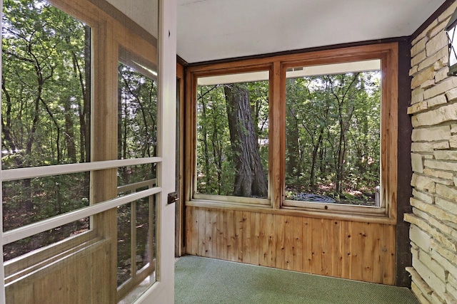 3023 Bruce Dr, Racine, WI 53404 - unfurnished sunroom featuring carpet flooring and wood walls