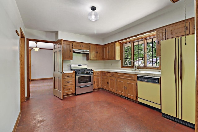 3023 Bruce Dr, Racine, WI 53404 - kitchen with white appliances, under cabinet range hood, light countertops, and brown cabinets