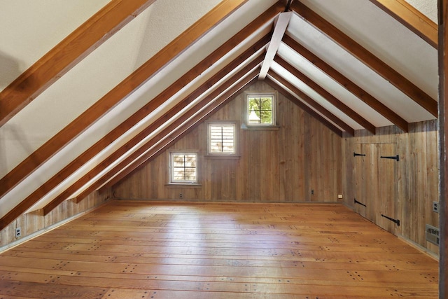 3023 Bruce Dr, Racine, WI 53404 - additional living space featuring vaulted ceiling, light wood-style floors, and wood walls
