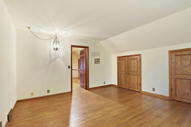 3023 Bruce Dr, Racine, WI 53404 - unfurnished room featuring light wood-type flooring and lofted ceiling