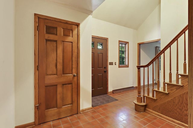 3023 Bruce Dr, Racine, WI 53404 - entryway featuring stairs, lofted ceiling, and tile patterned floors