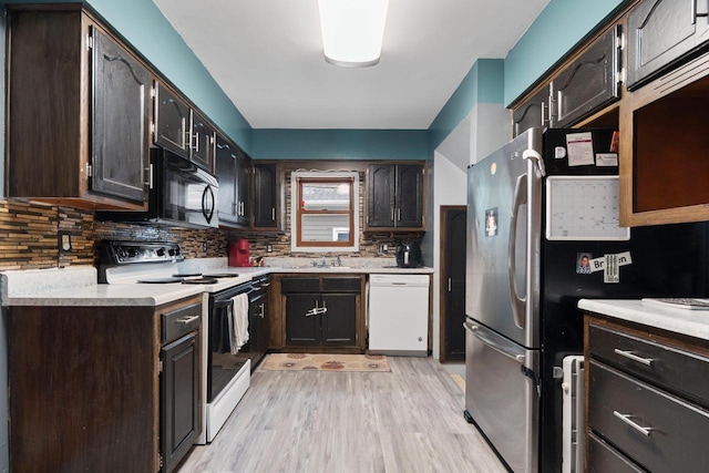 1418 W Washington St, Appleton, WI 54914 - kitchen with dishwasher, range with electric cooktop, freestanding refrigerator, black microwave, and light wood-style floors